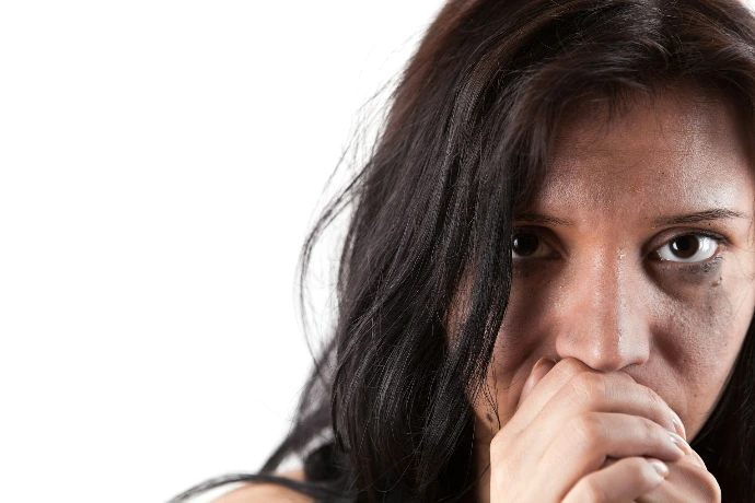 A woman covers her mouth with her hands